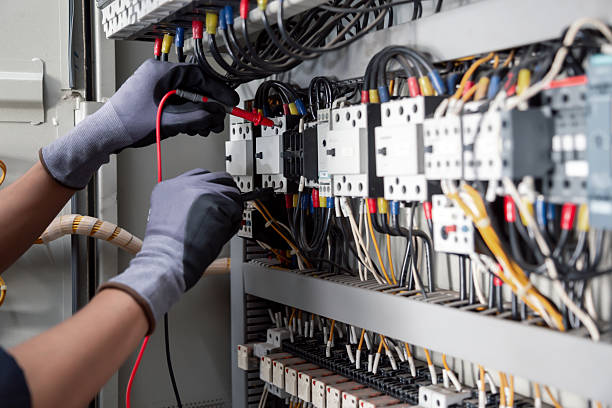 Electricity and electrical maintenance service,Electrical tests industrial electrical circuits with a multimeter in the control terminal box.