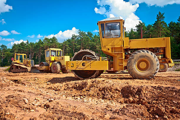 Steamrollers and bulldozer on a road construction