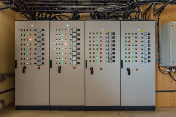 Electrical switchgear cabinets with control panels with indicator lights in factory.