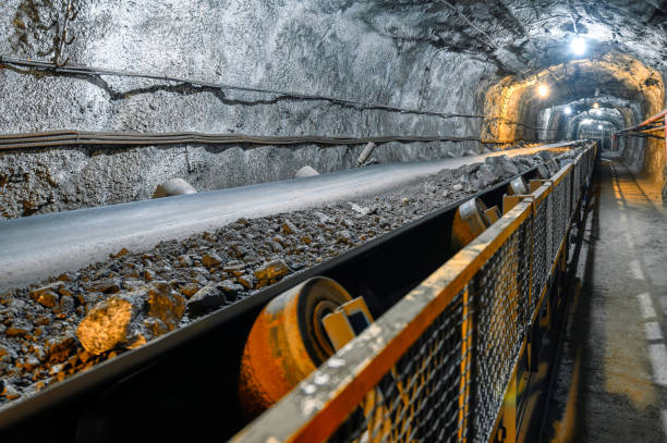 Belt conveyor in an underground tunnel. Transportation of ore to the surface.